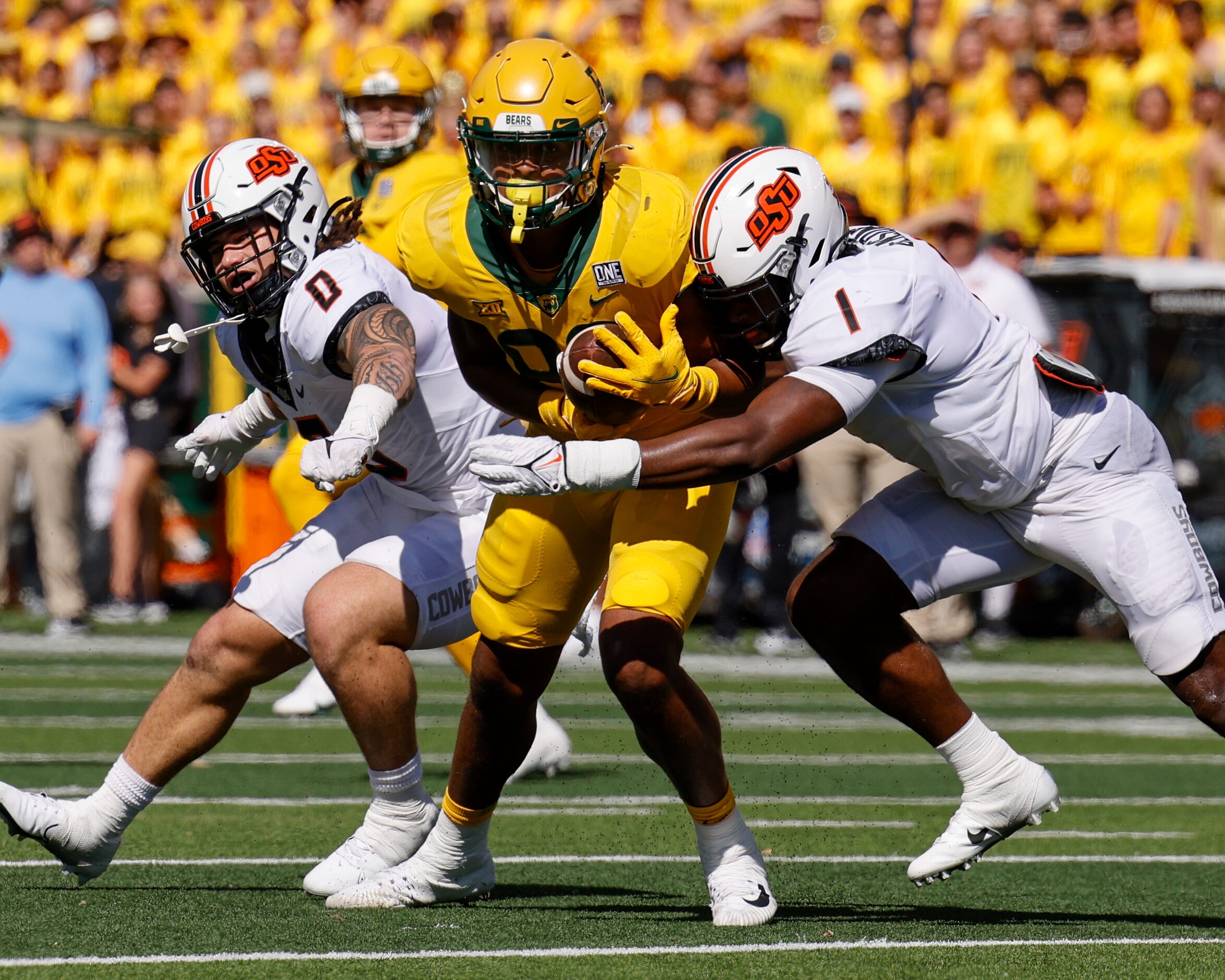 Oklahoma State linebacker Xavier Benson (1) tackles  Baylor tight end Drake Dabney (89)...