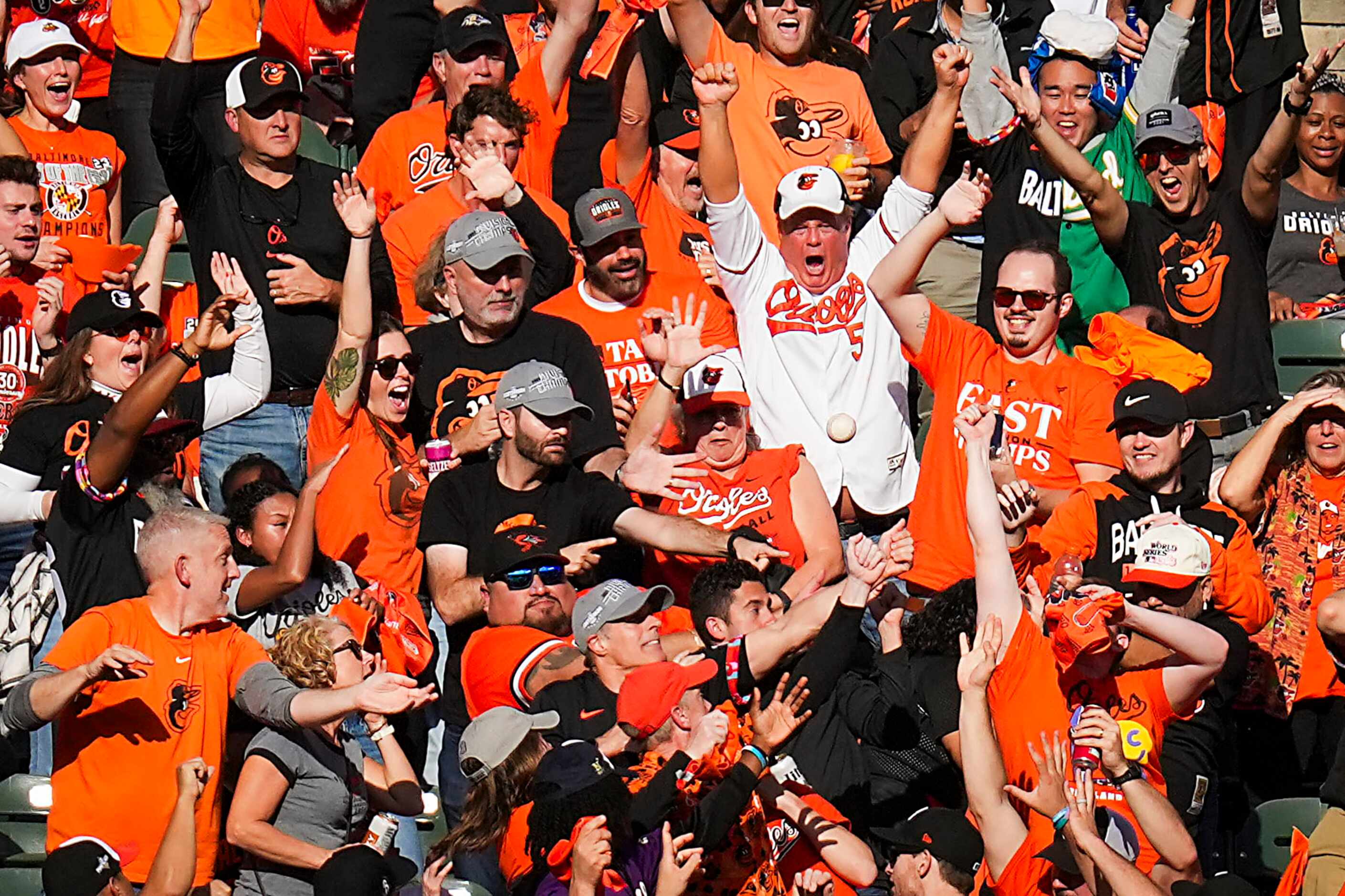 Fans reach for a home run ball off the bat of Baltimore Orioles designated hitter Anthony...