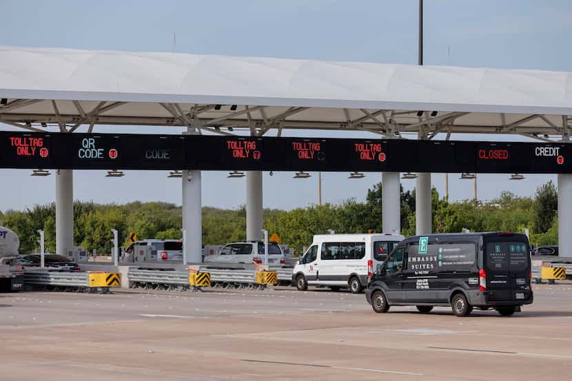 Vehicles stop at toll booths at the Dallas Fort Worth International Airport's south entrance.