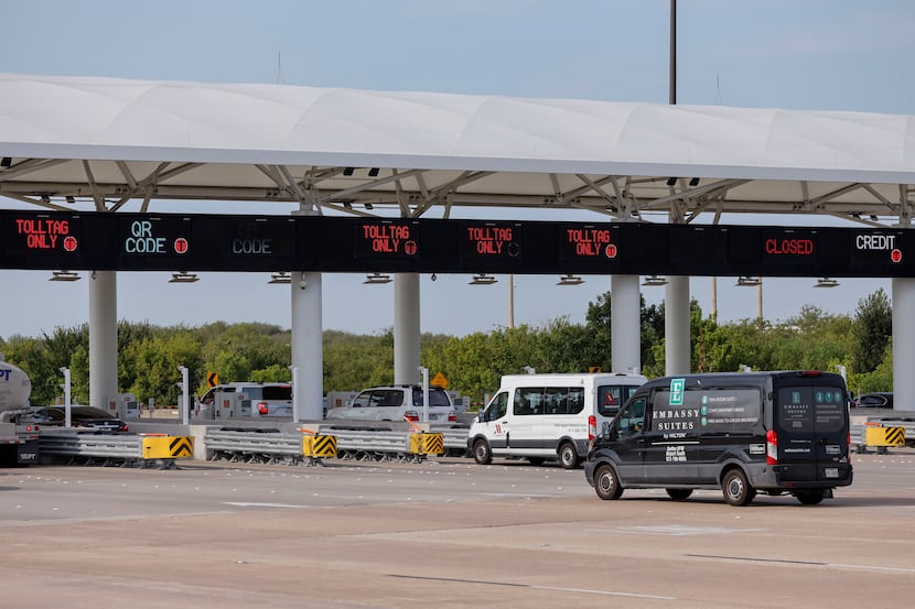 Vehicles stop at toll booths at DFW International Airport's south entrance.