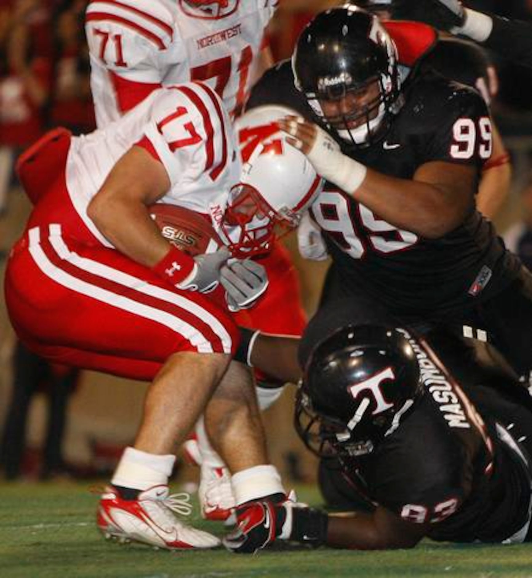 Justin Northwest senior running back Tyler Collins (17) is stopped by Euless Trinity...