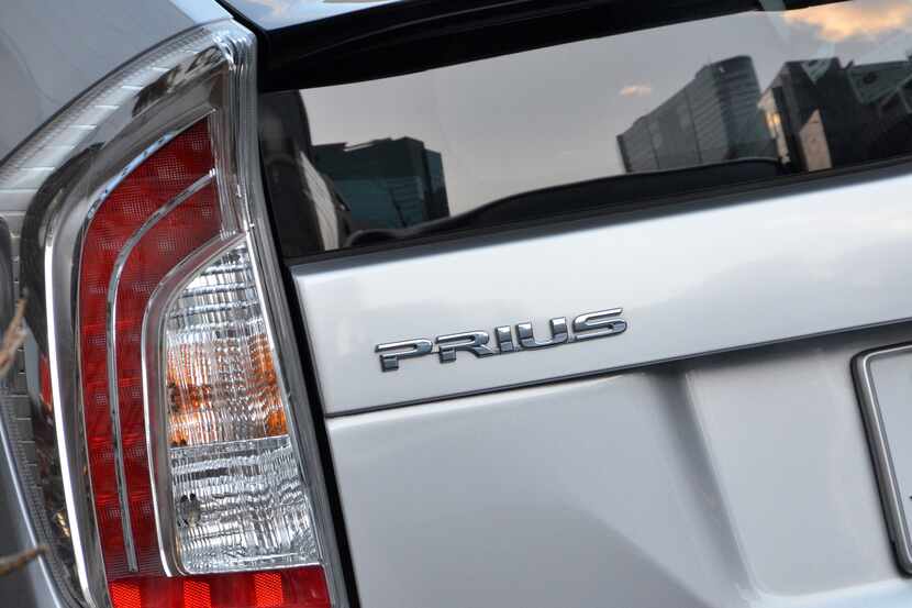A logo of Japanese auto giant Toyota Motor's hybrid vehicle Prius is displayed on one of its...