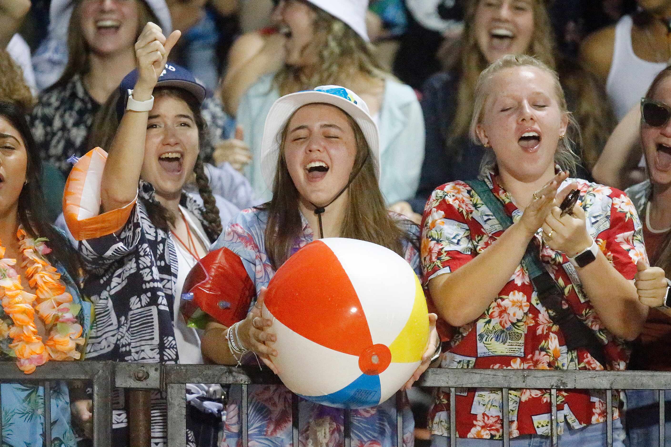 The Melissa High School student section celebrates a score during the first half as Melissa...