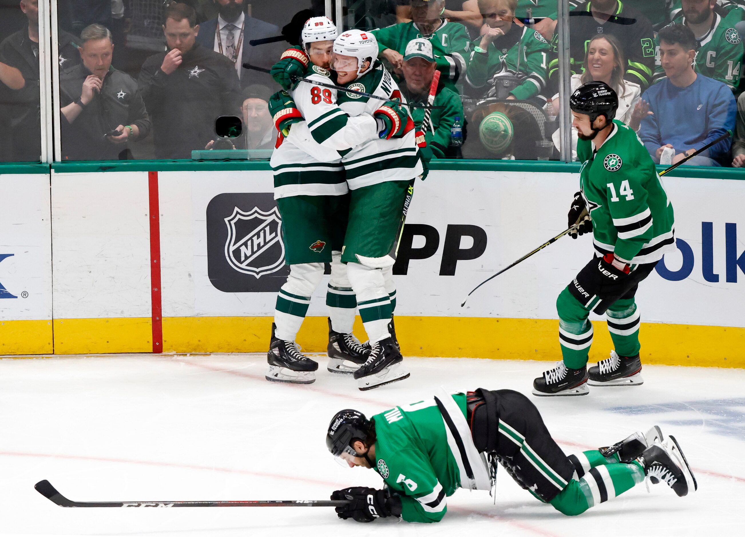 Dallas Stars defenseman Colin Miller (6) is slow to get up after Minnesota Wild center...