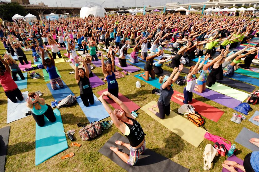 Yoga enthusiasts participate in the Wanderlust group yoga and mediation session following...