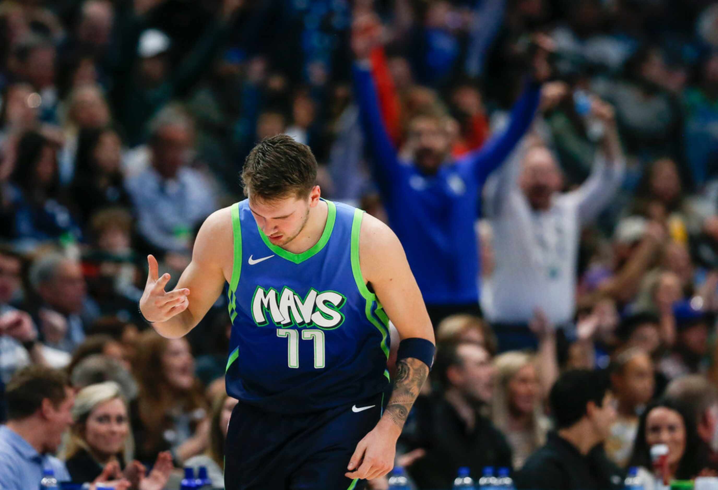 Dallas Mavericks forward Luka Doncic (77) celebrates sinking a three pointer during the...