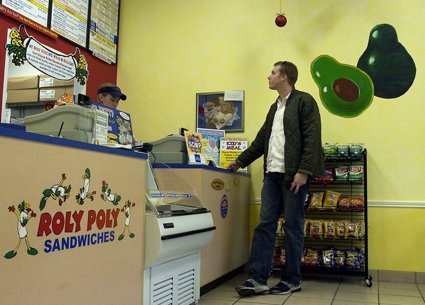 Richard Wade looks over the menu at Roly Poly Sandwiches, which also no longer exists, at...