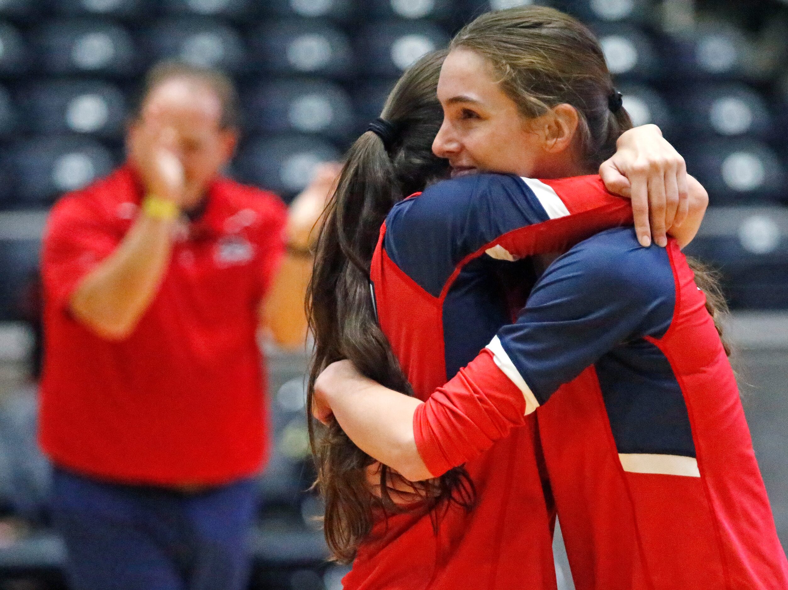 Aubrey High School’s Annaleise Sevier (9) embraces team mate Olivia Starr (10) after winning...