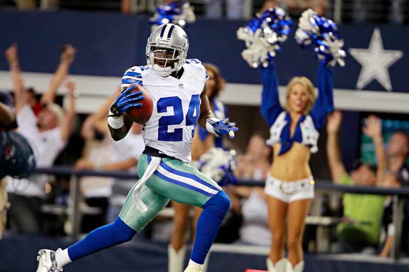 Fans and cheerleaders react as Dallas Cowboys cornerback Morris Claiborne runs in a...