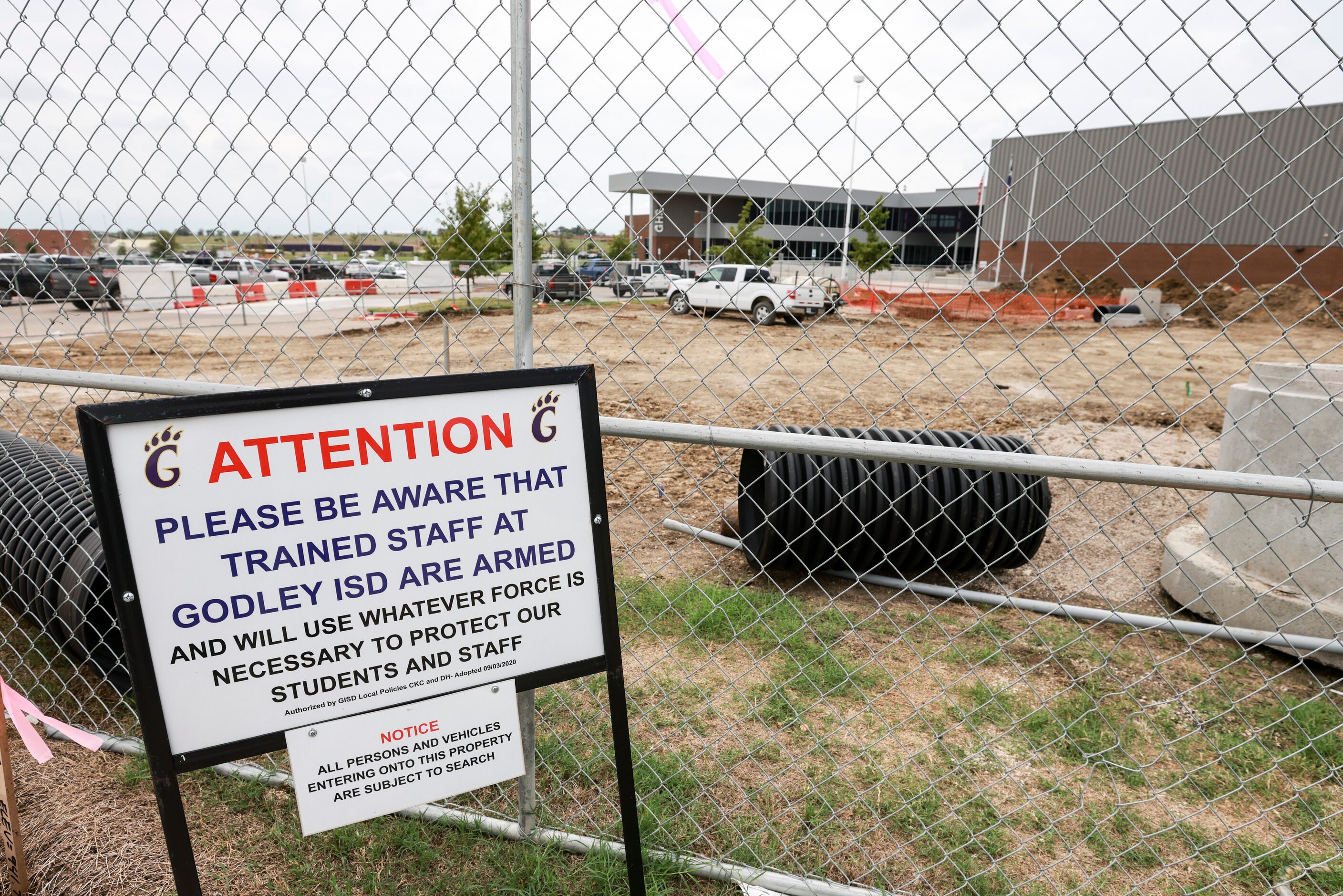 A sign outside Godley High School informs the public that there are armed staff members at...