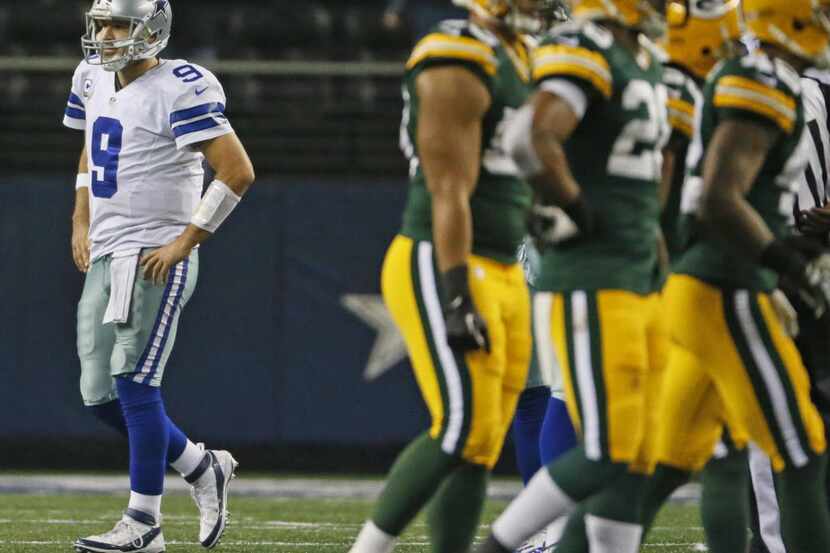 Dallas Cowboys quarterback Tony Romo (9) walks off the field after throwing his second...