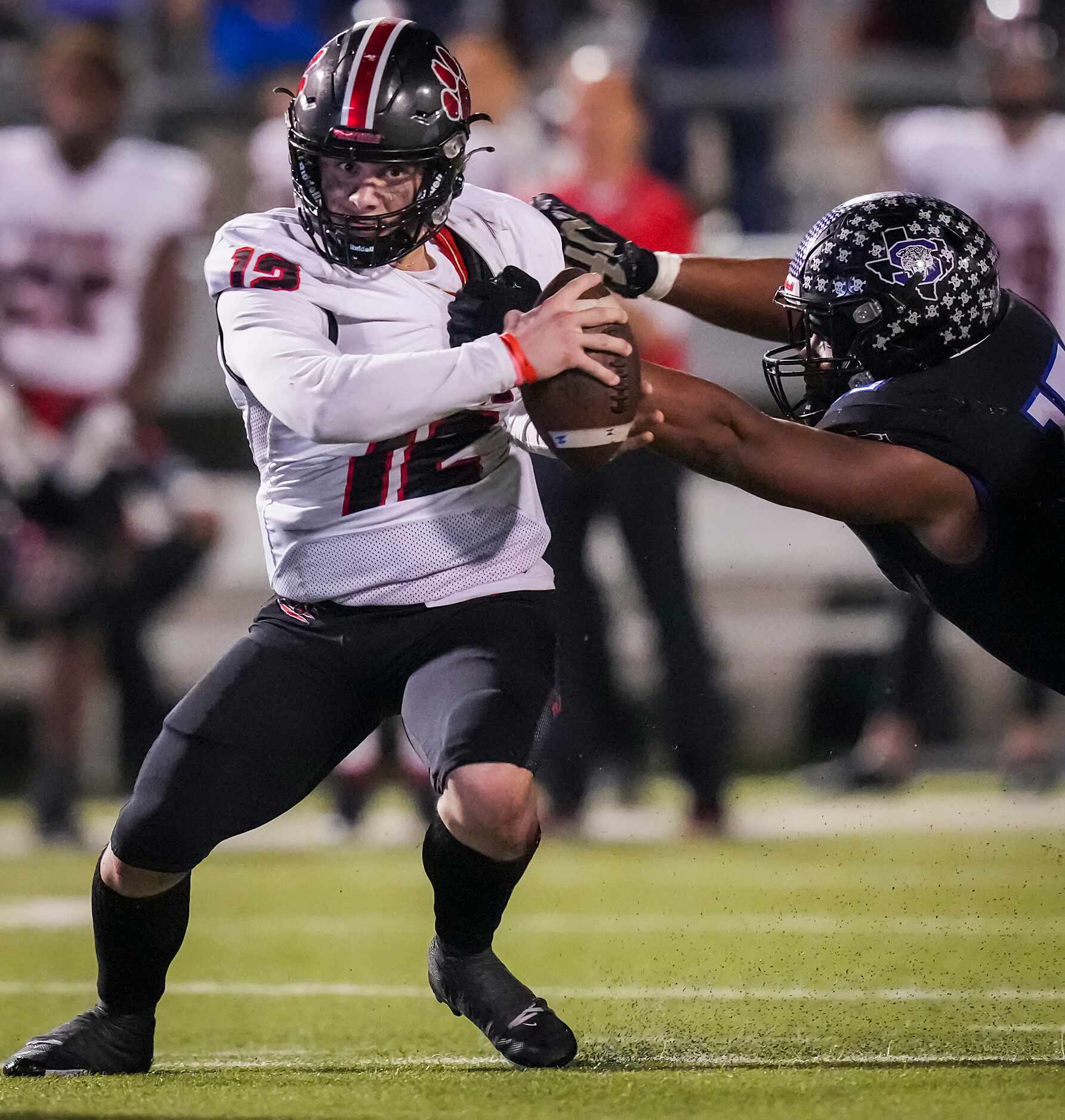 Colleyville Heritage quarterback Luke Ullrich (12) is brought down by Mansfield Summit...