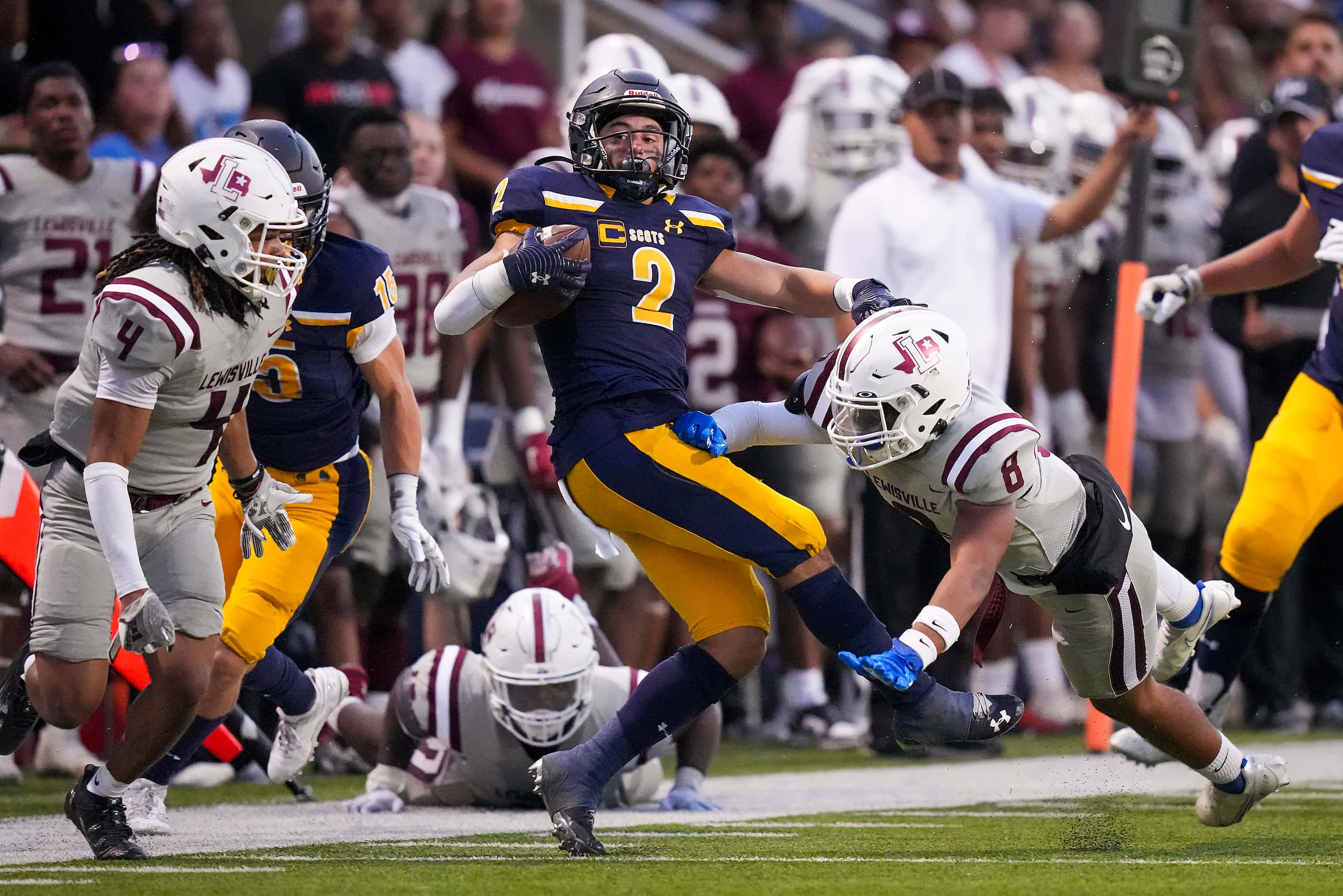 Highland Park running back Wilson Axley (2) is knocked out of bounds by Lewisville...
