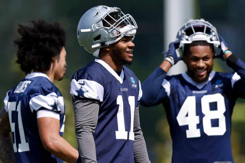 Dallas Cowboys first round linebacker Micah Parsons (11) laughs with teammates Anthony Hines...