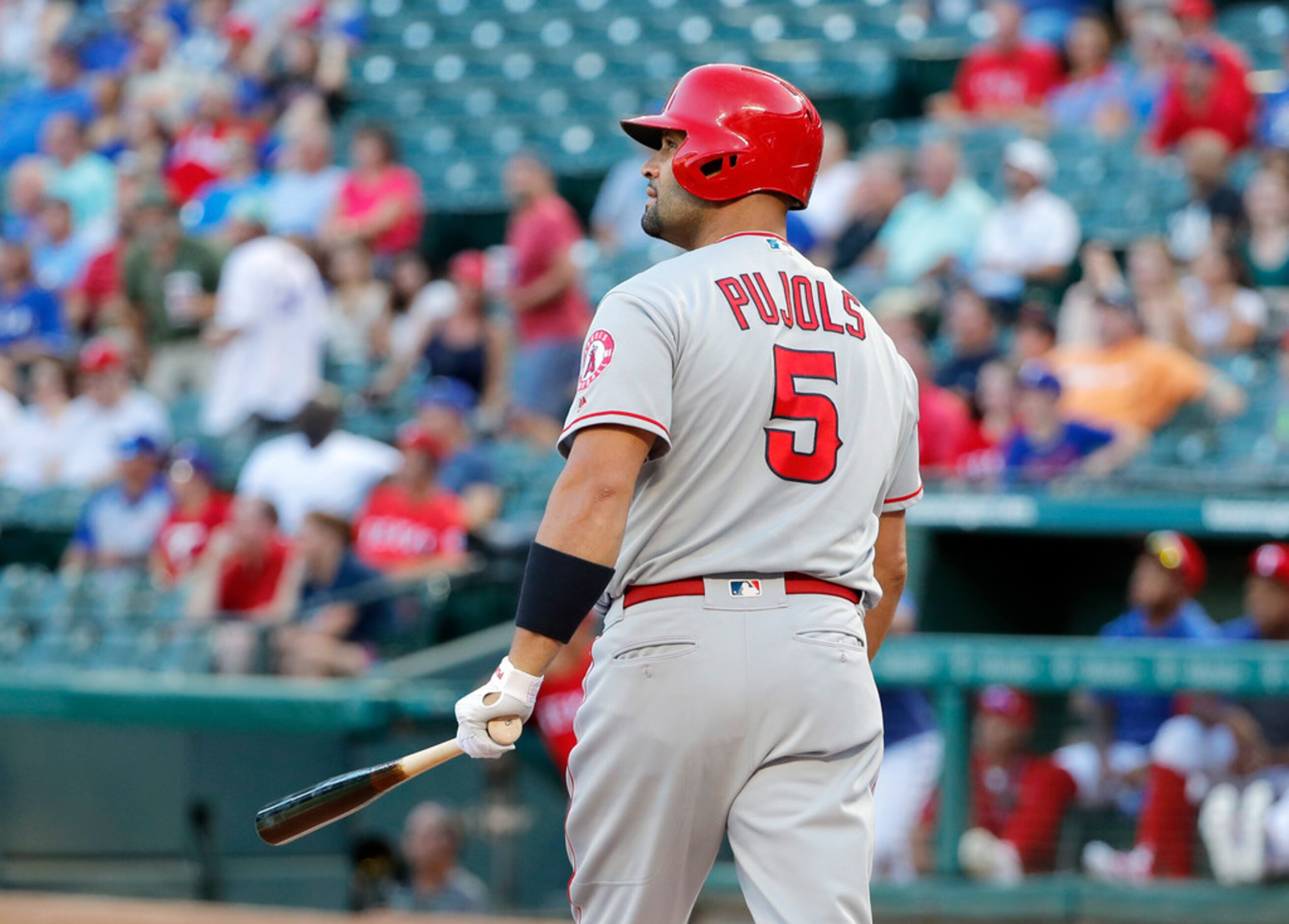 Los Angeles Angels' Albert Pujols watches his three-run home run ball off a pitch from Texas...