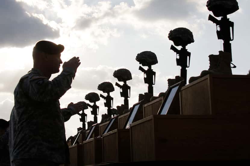 In this 2009 file photo, soldiers salute as they honor victims of the Fort Hood shooting at...