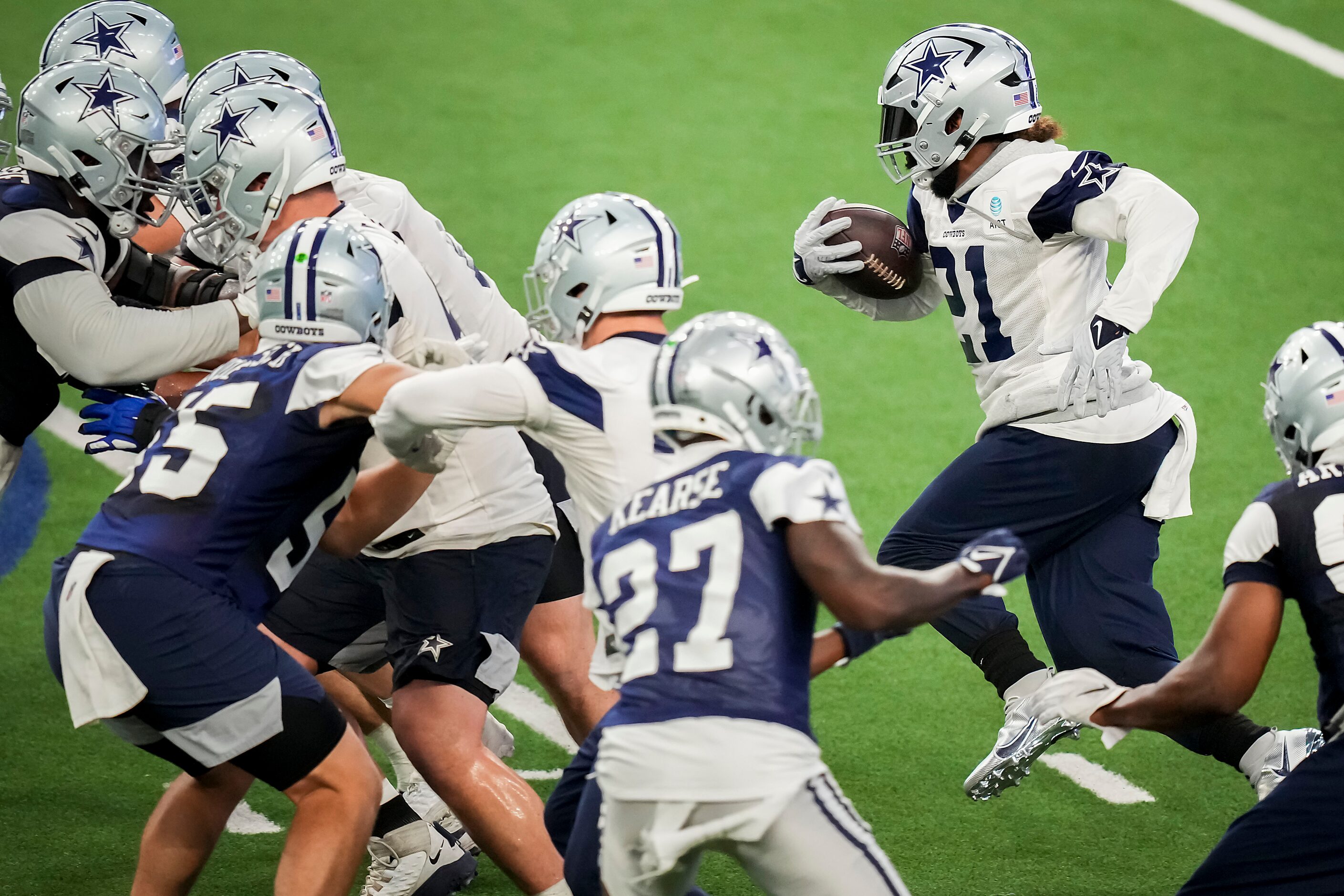 Dallas Cowboys running back Ezekiel Elliott (21) runs the ball during the team's OTA...