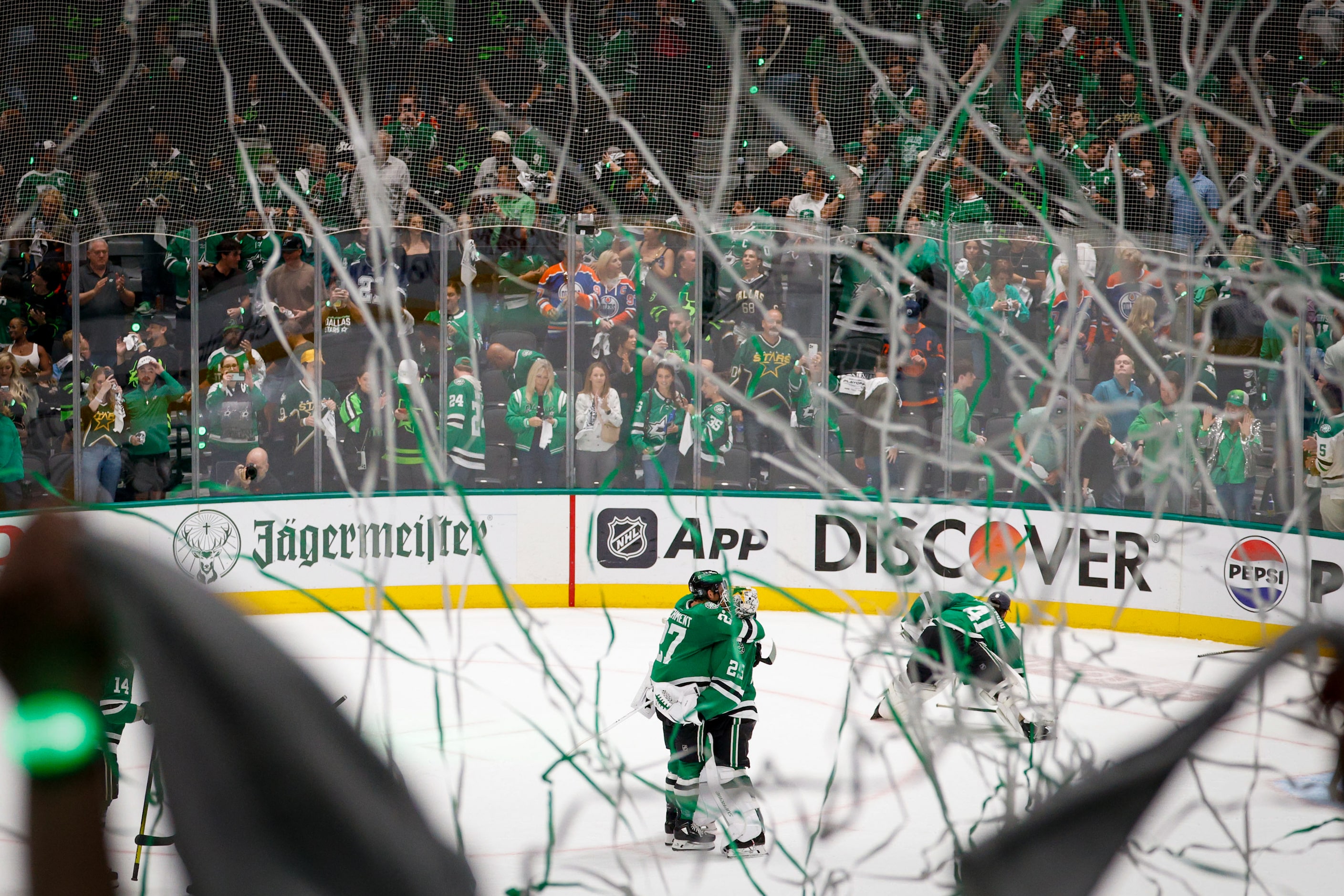 Dallas Stars left wing Mason Marchment (27) hugs goaltender Jake Oettinger (29) after their...