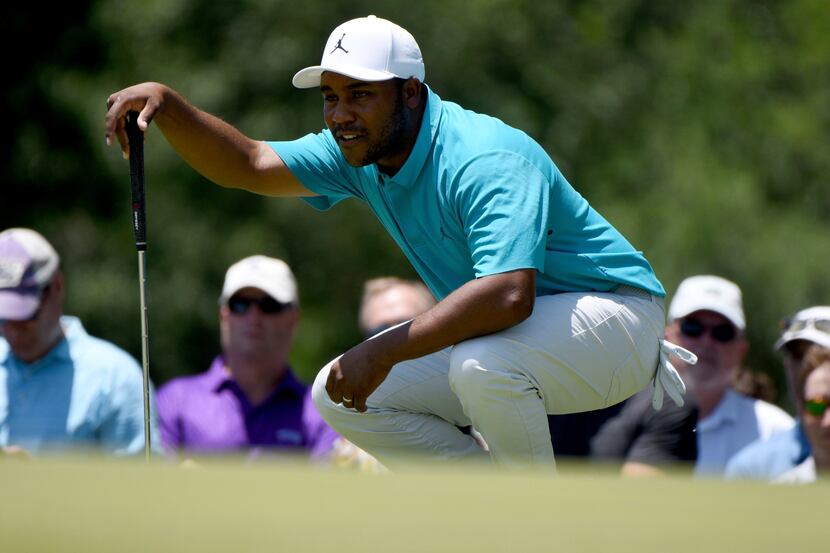 Harold Varner III prepares to putt on the second green during the third round of the Charles...