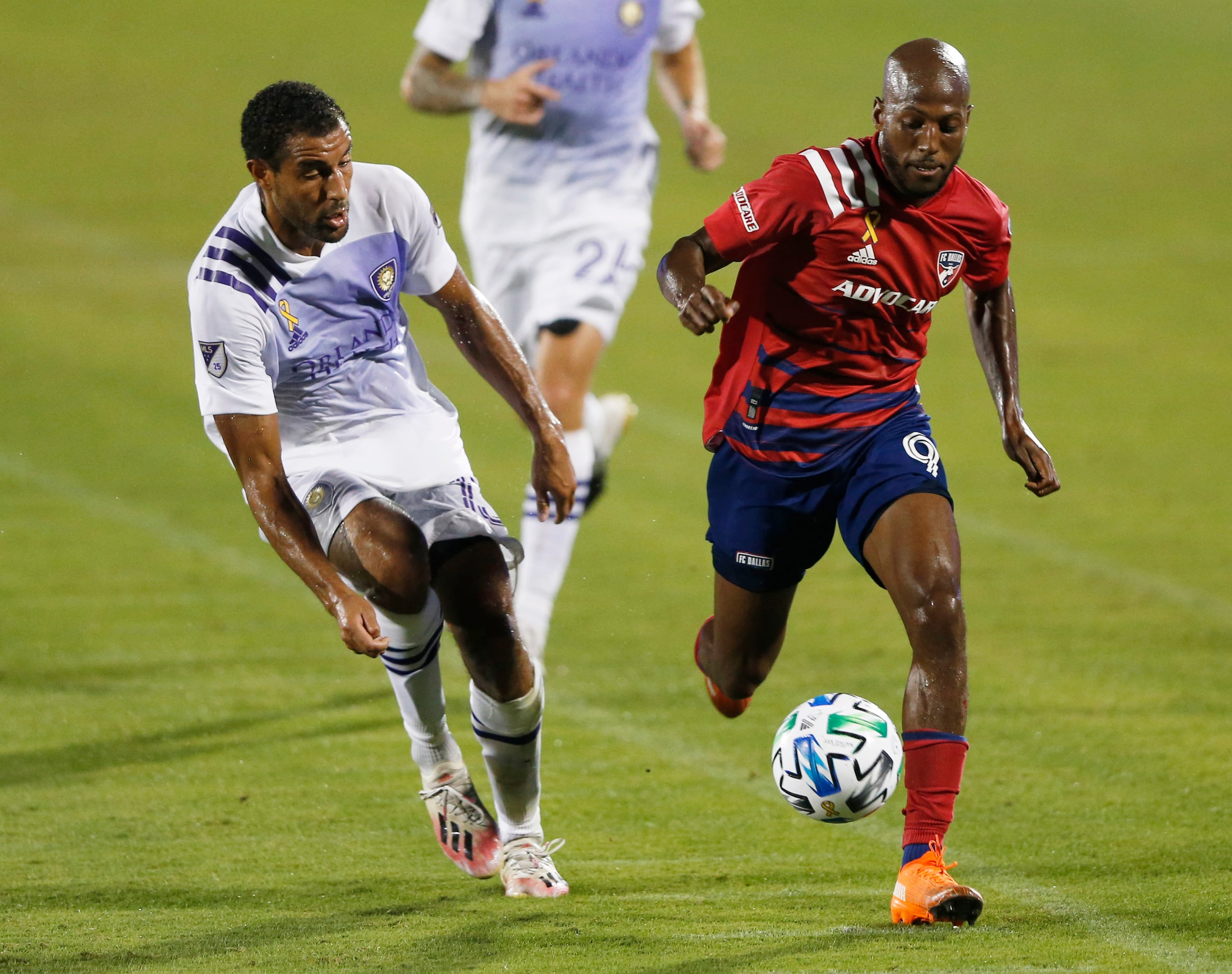 FC Dallas forward Fafa Picault (9) advances the ball as Orlando City forward Tesho Akindele...