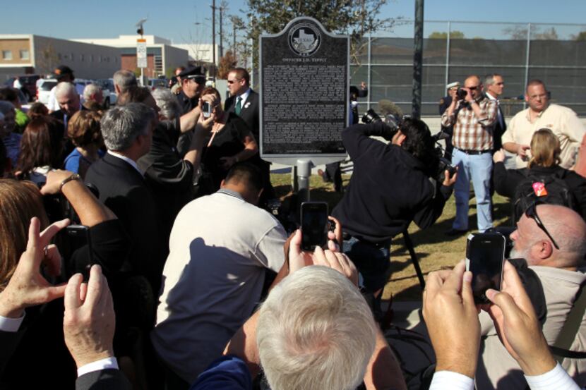 A crowd gathered around the historical marker placed at the intersection of 10th and Patton...