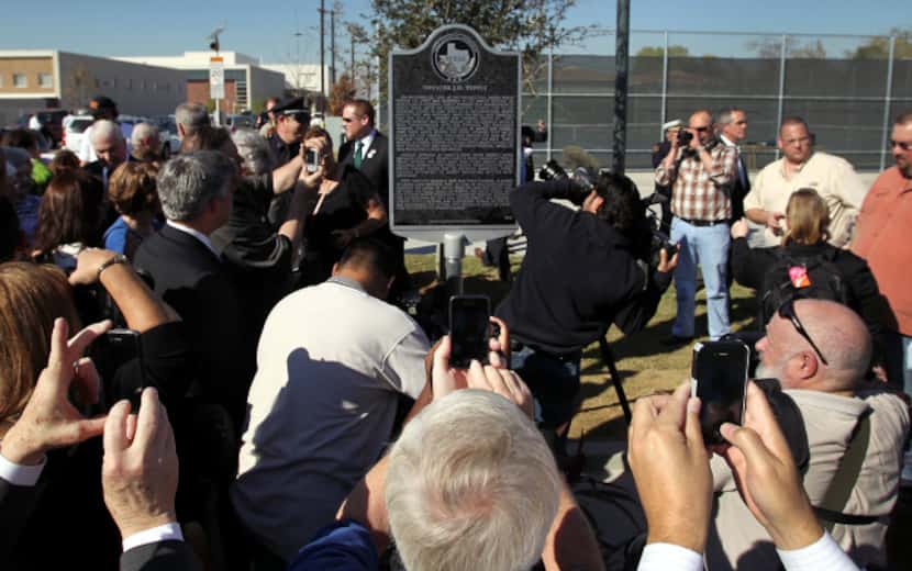 A crowd gathered around the historical marker placed at the intersection of 10th and Patton...
