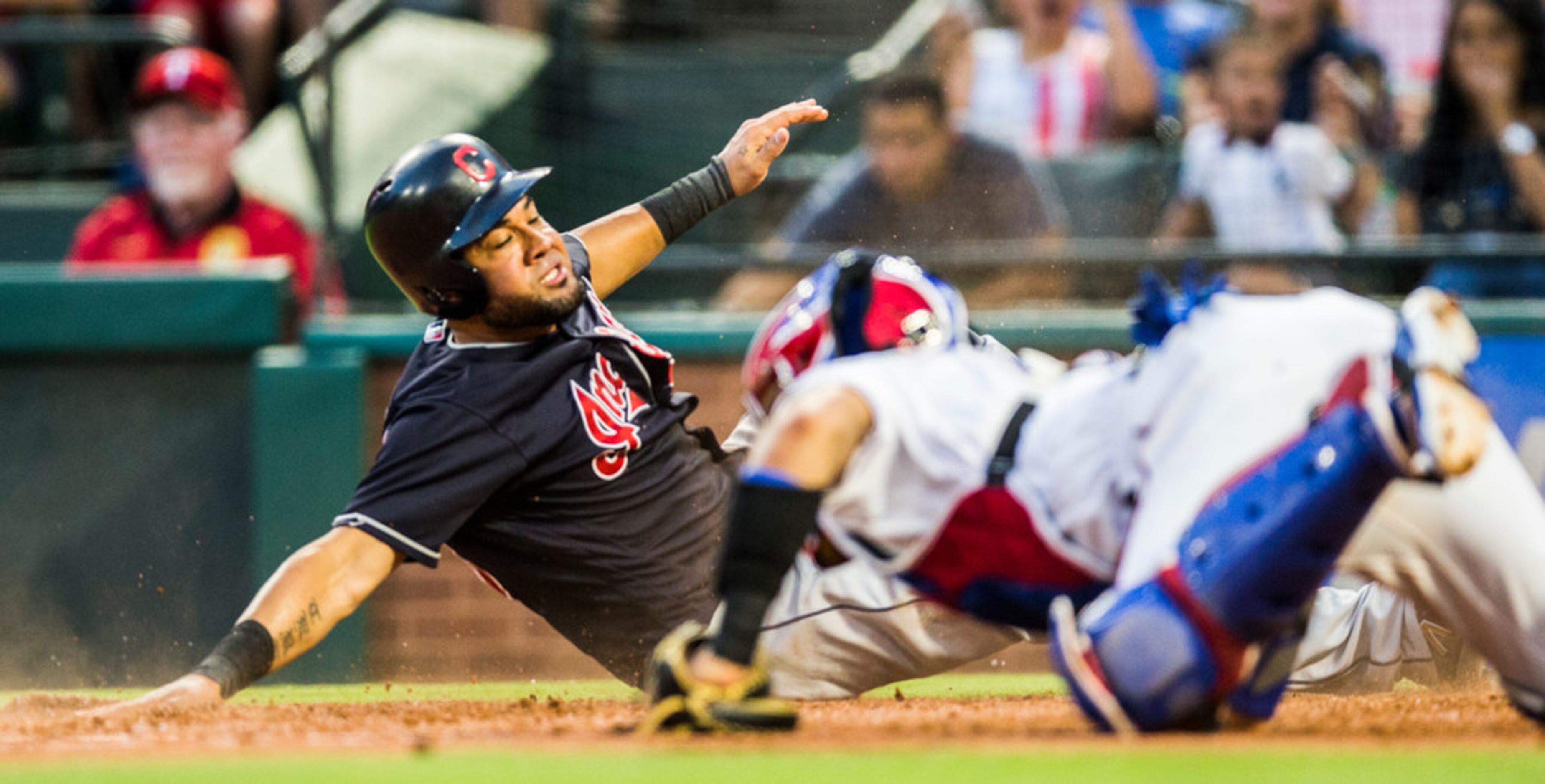 Texas Rangers catcher Robinson Chirinos (61) is out of reach of Cleveland Indians center...