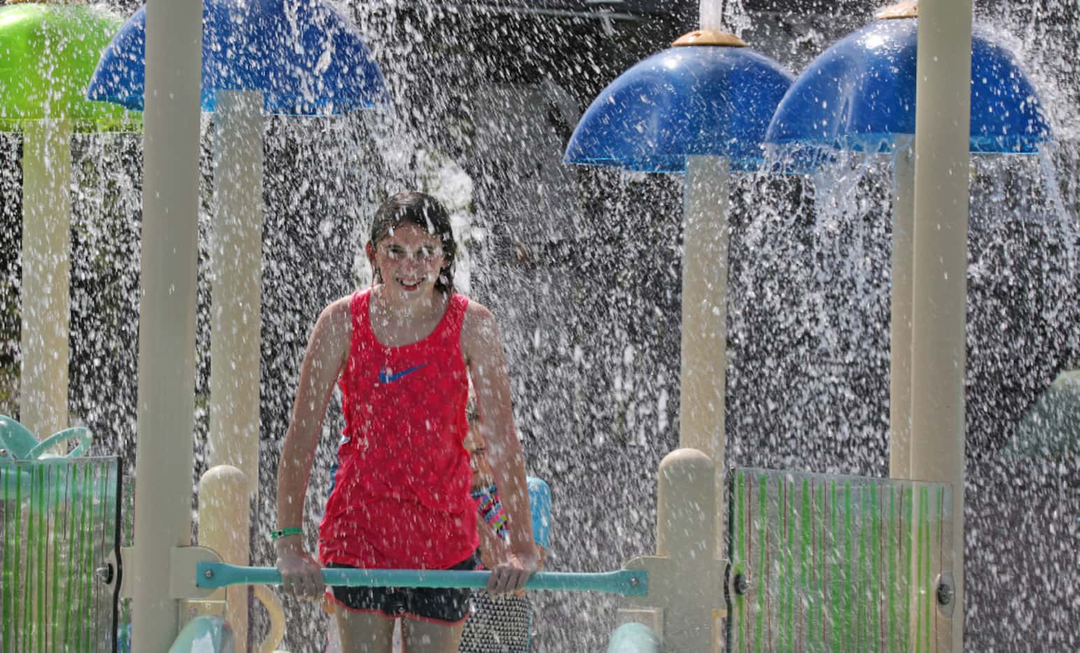 Young swimmers enjoy a shower of water on one of the many play areas at JadeWaters, the...
