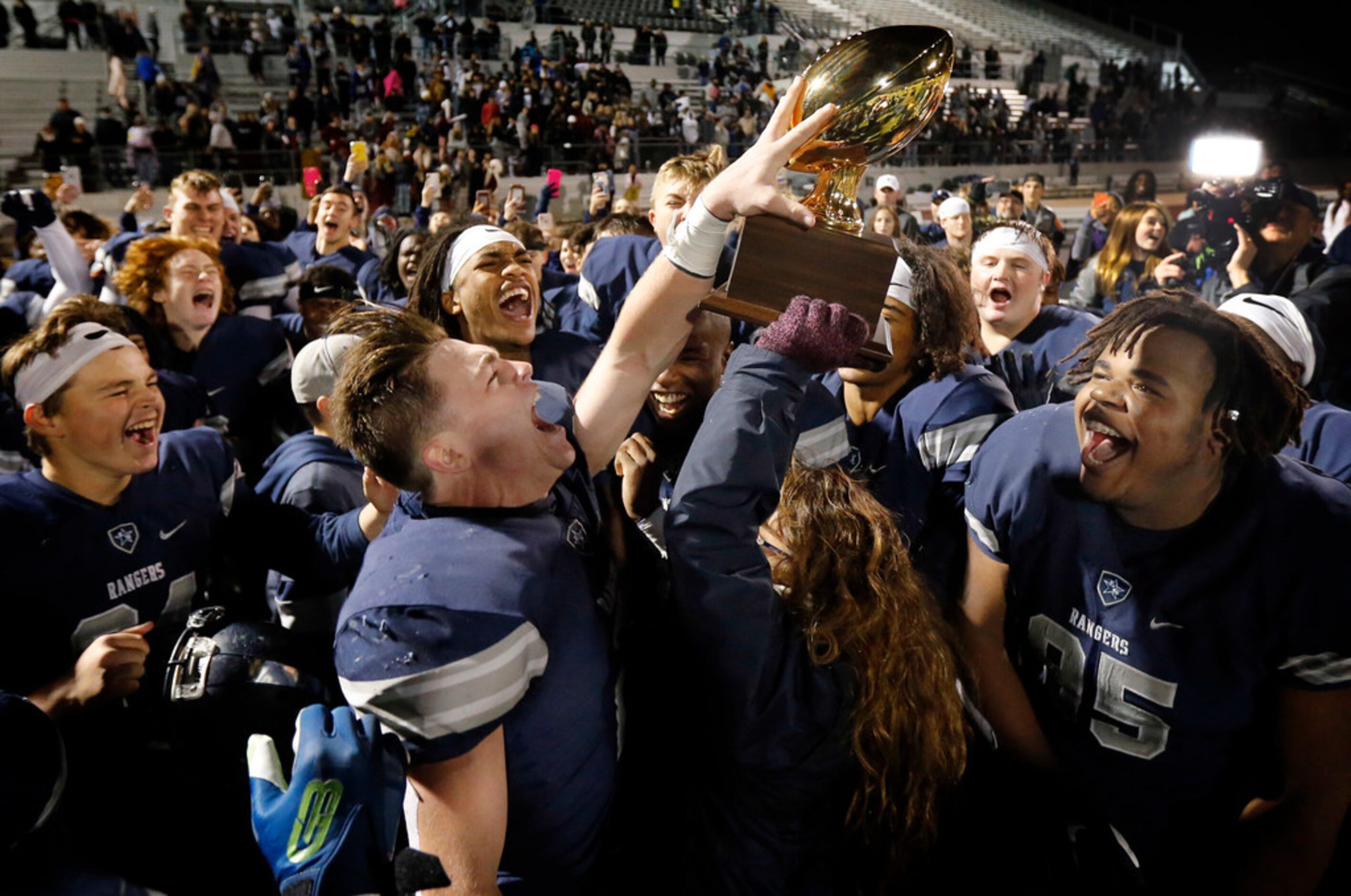 Frisco Lone Star players including receiver Jake Bogdon (2) and Cameron Jones (95) celebrate...