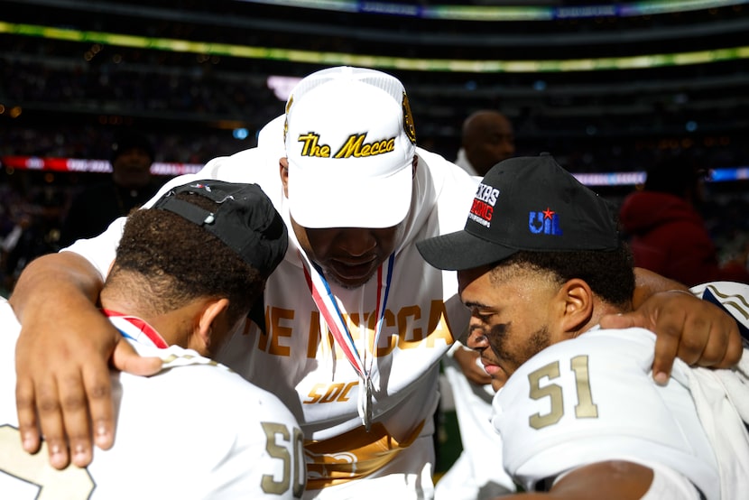 South Oak Cliff head coach Jason Todd (center) comforts Jordan Smith-rowe (left) and Jaden...