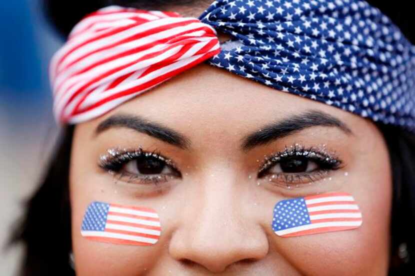 
Karina Cisneros of Dallas wore flag face paint and a bandanna to show her support for the...