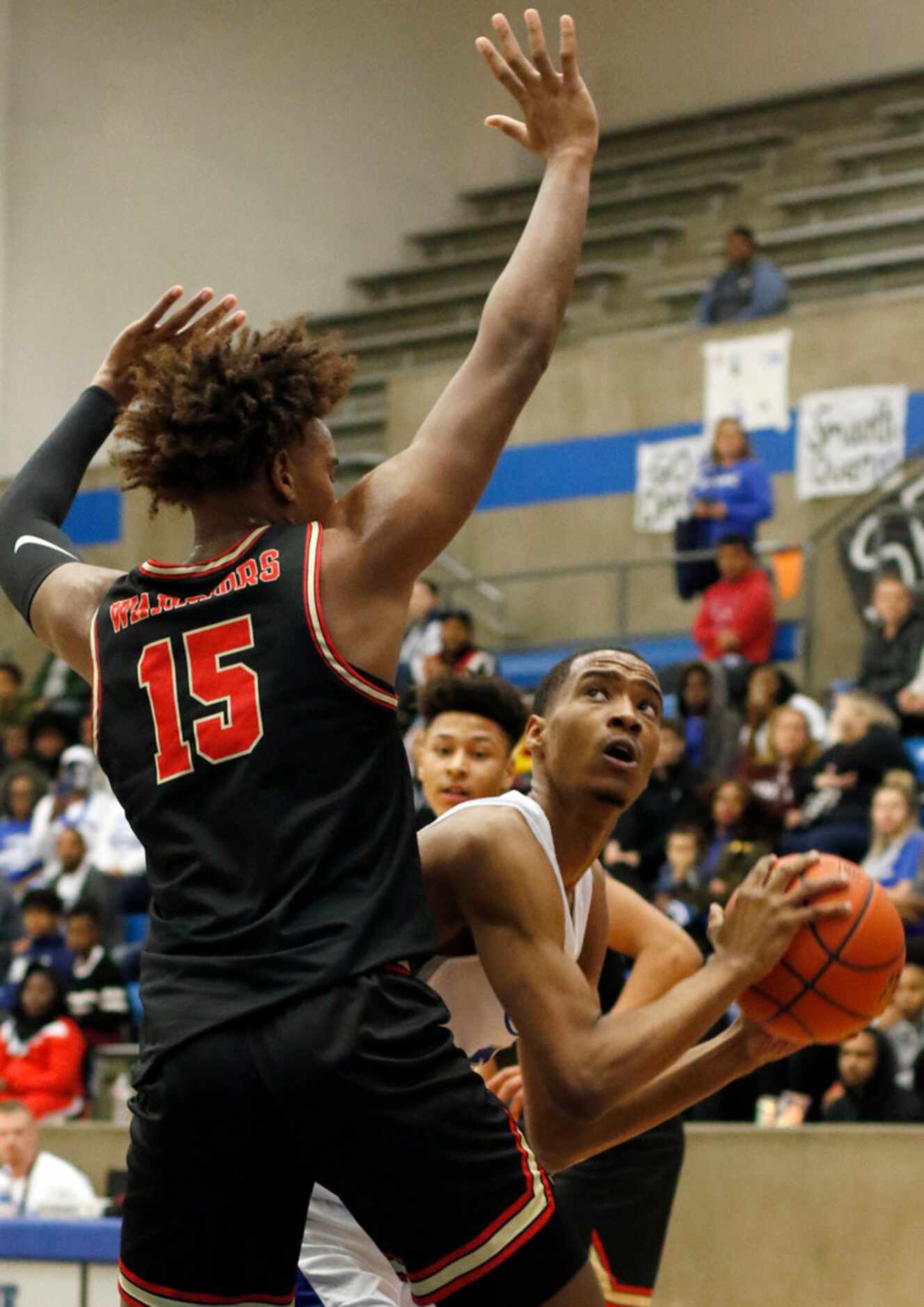 Grand Prairie's Donald Ghostone (2) eyes a shot as he is defended by South Grand Prairie's...