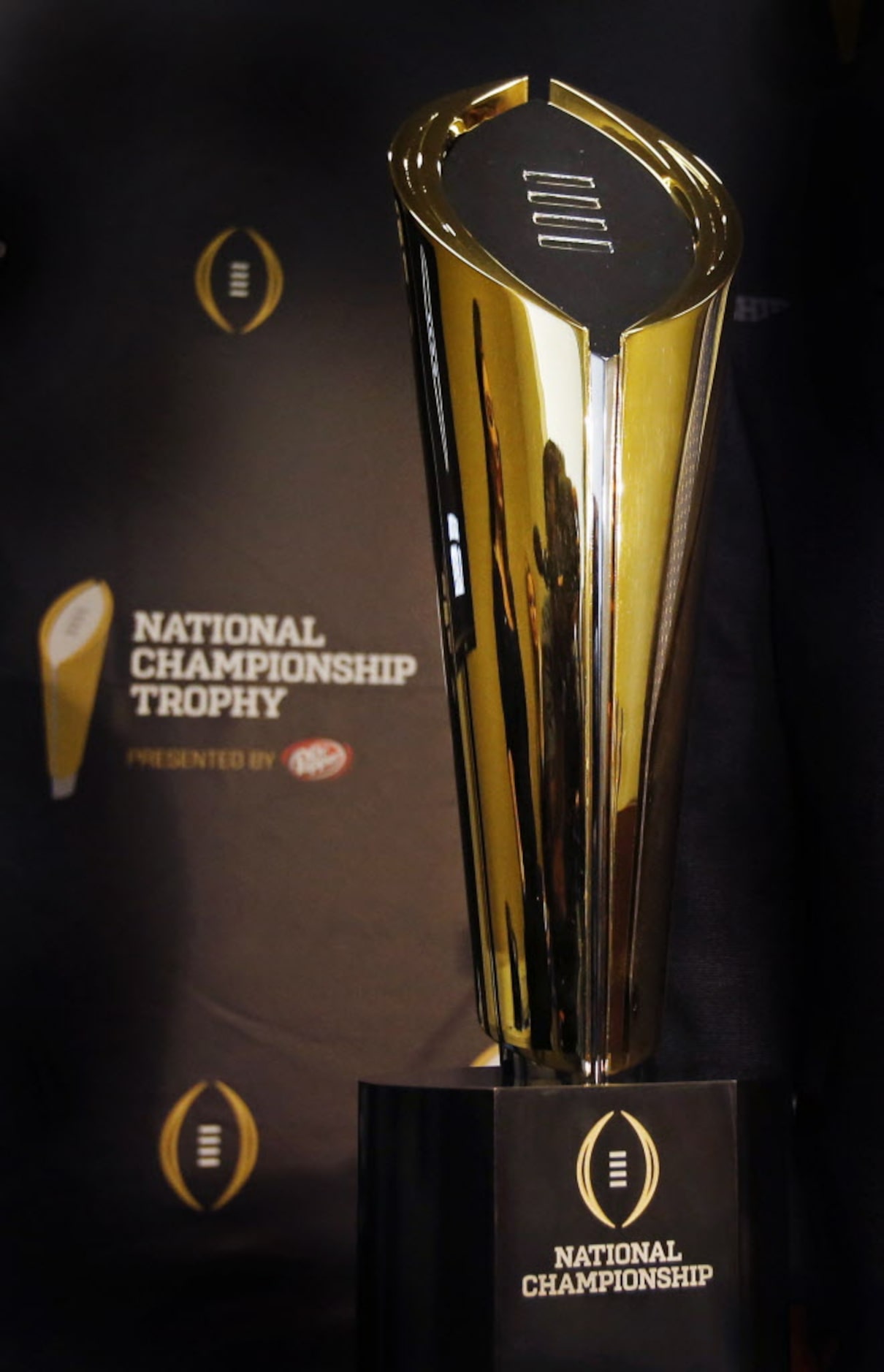 The new national championship trophy for the College Football Playoff is unveiled at a press...