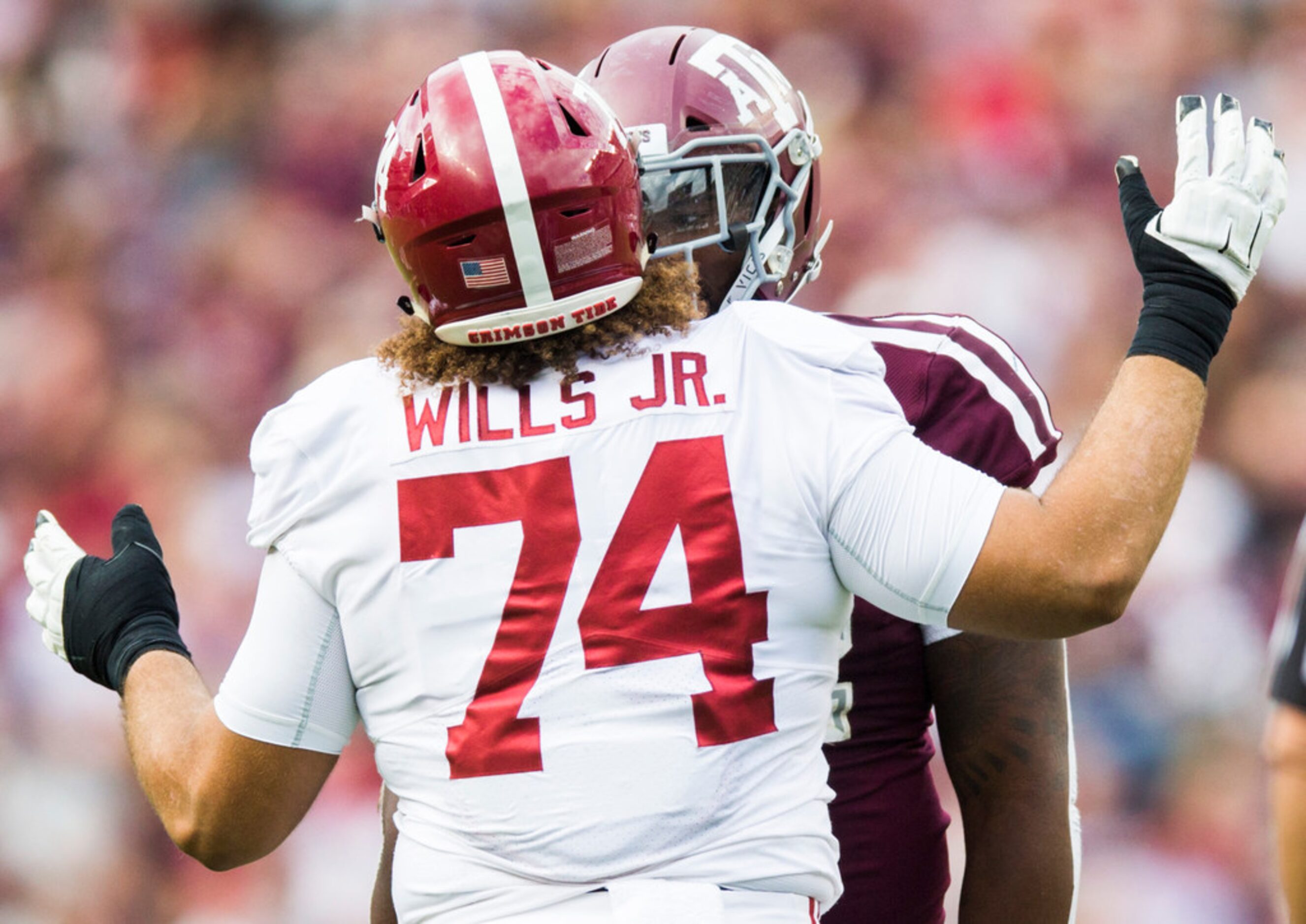 Alabama Crimson Tide offensive lineman Jedrick Wills Jr. (74) exchanges words with Texas A&M...