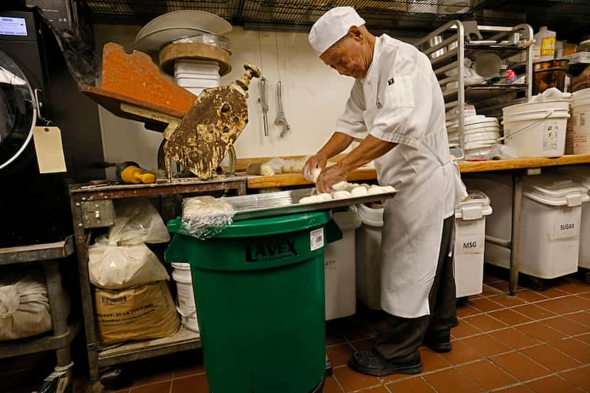 Yuan Hai Teng, co-founder of Jeng Chi restaurant, prepares dough to make buns at his...