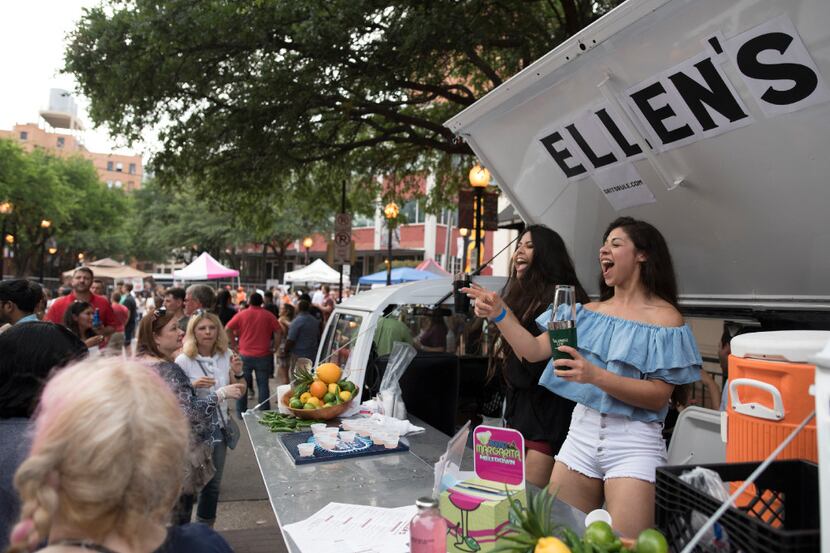 Denisse Carrera, left, and Italia Sanches serve margaritas offered by Ellen's during the...