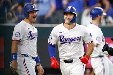 Texas Rangers first baseman Nathaniel Lowe (30) yells as he celebrates a grand slam by left...
