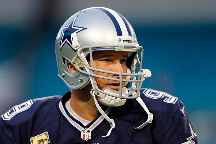 Dallas Cowboys quarterback Tony Romo warms up before their game against the Miami Dolphins...