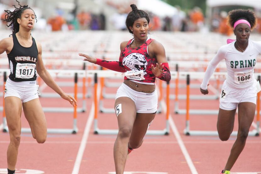 Mesquite Horn's Kaylor Harris, center, takes first in the girls 100 meter hurdles with a...