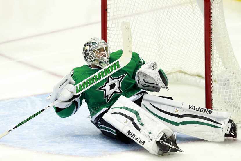 Dallas Stars goalie Antti Niemi (31) ended up on his back after being scored on by Minnesota...