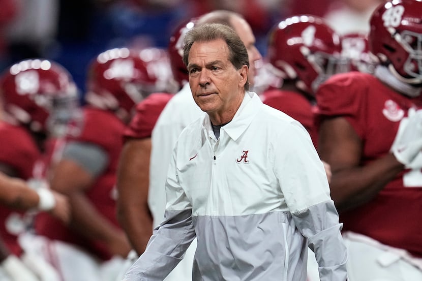 FILE - Alabama coach Nick Saban watches players warm up for the College Football Playoff...