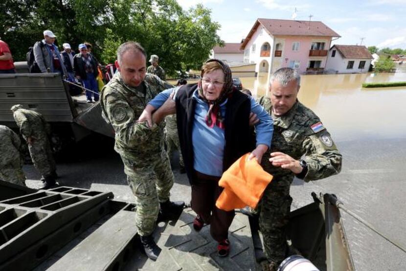 
Rescue workers helped a woman to safety Sunday in eastern Croatia. After three months’...