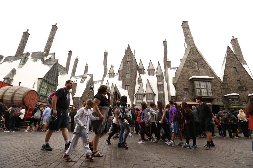 Enthusiastic visitors explore The Wizarding World of Harry Potter at Universal Studios...