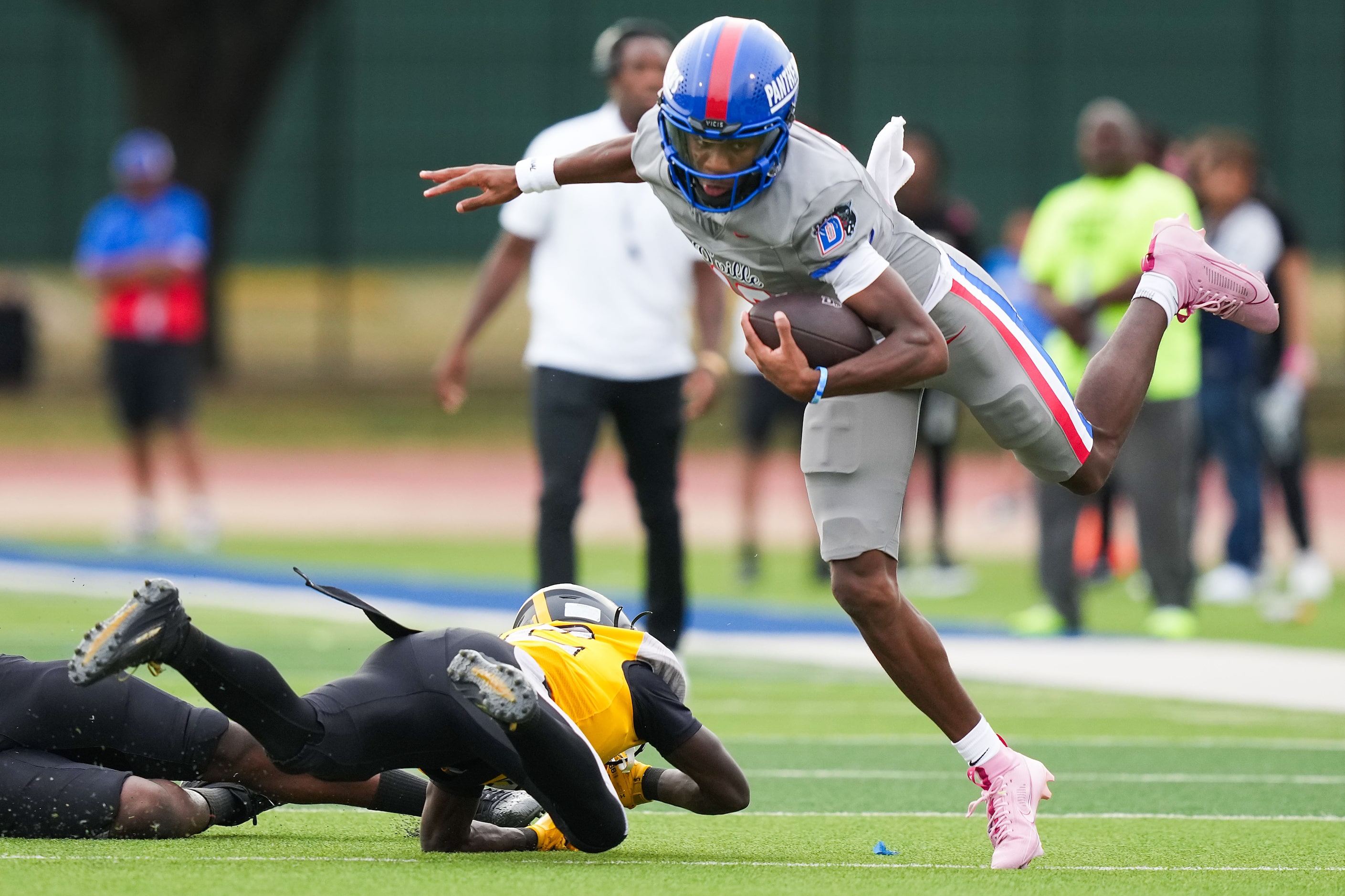 Duncanville quarterback Keelon Russell gets past St. Frances Academy defensive back Wayne...