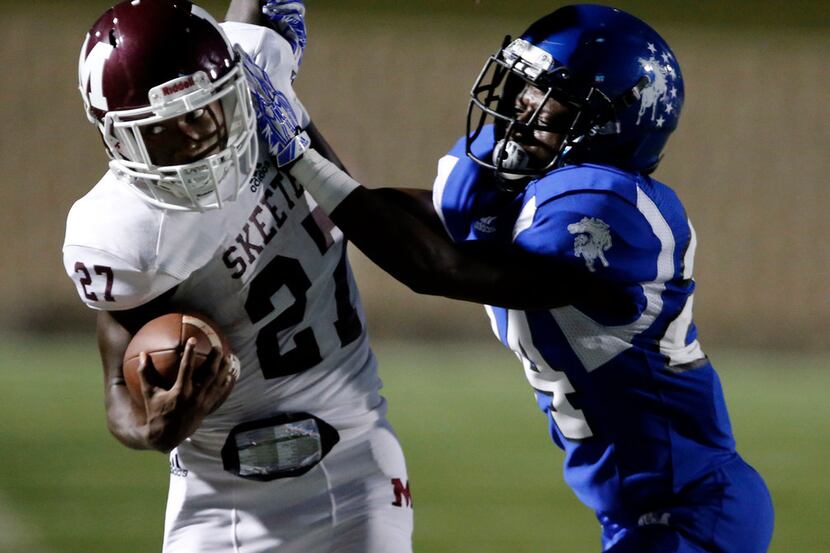 Mesquite WR Ja'Darion Smith (27) is pushed out of bounds by North Mesquite defender Daniel...