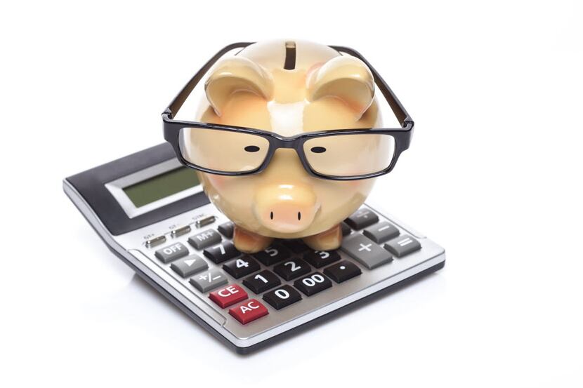 piggybank with glasses and a calculator isolated on white  background