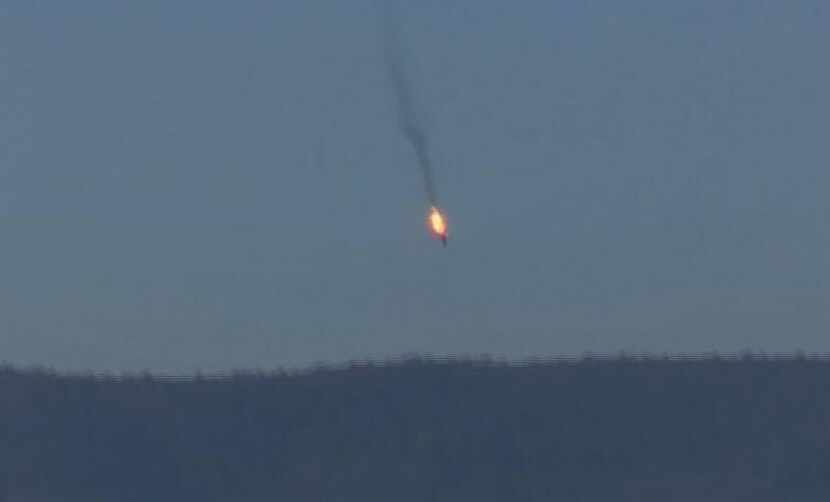 This frame grab from video by Haberturk TV, shows a burning Russian warplane plummeting into...