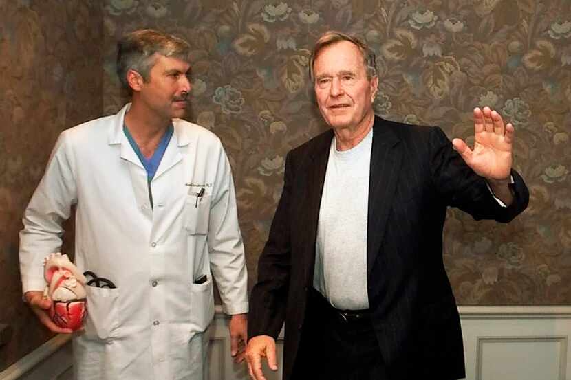 President George H.W. Bush waved as he left Methodist Hospital with his cardiologist, Mark...