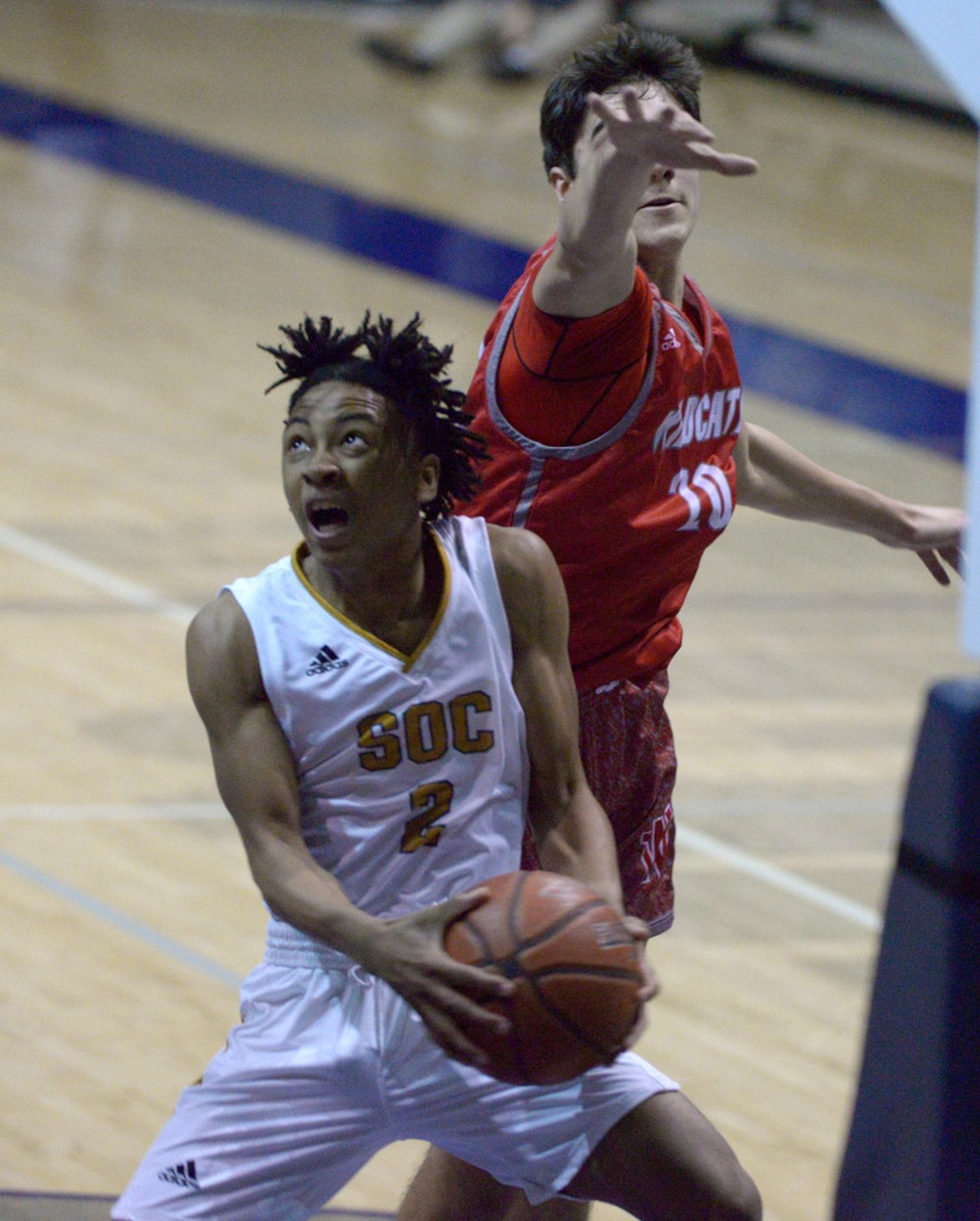 South Oak Cliff's DeJuan Leffall (2) tries to shoot around Woodrow Wilson's Beau Becker in...