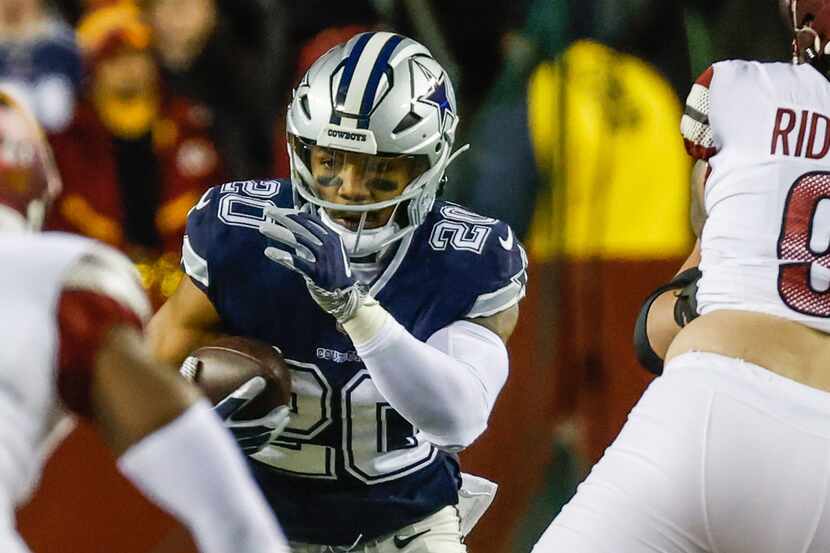 Dallas Cowboys running back Tony Pollard (20) runs with the football during the first half...